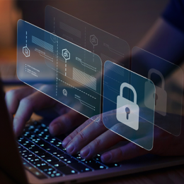 Laptop with person's hands on the keyboard and a holographic image of a padlock and internet security