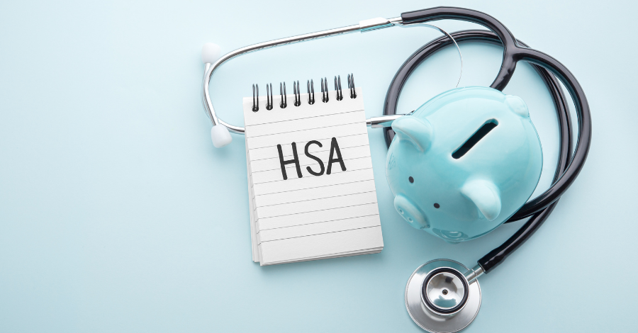 Notepad that says HSA on it with stethoscope and baby blue piggy bank