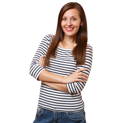 Woman with light skin and dark brown hair wearing white and black striped shirt smiling facing the camera with arms crossed