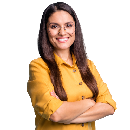 Woman with light skin and dark brown hair wearing thin round glasses a yellow button down shirt smiling looking at camera with arms crossed
