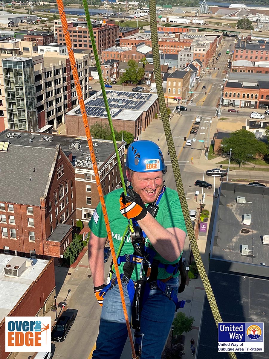 MidWestOne Employee Brock Renbarger going over the edge of the MidWestOne Bank Dubuque building