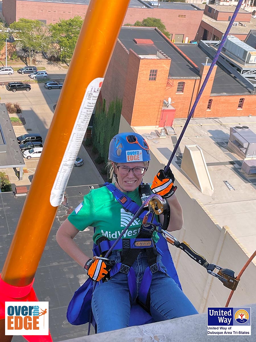 MidWestOne Employee Kari Fair going over the edge of the MidWestOne Bank building in Dubuque