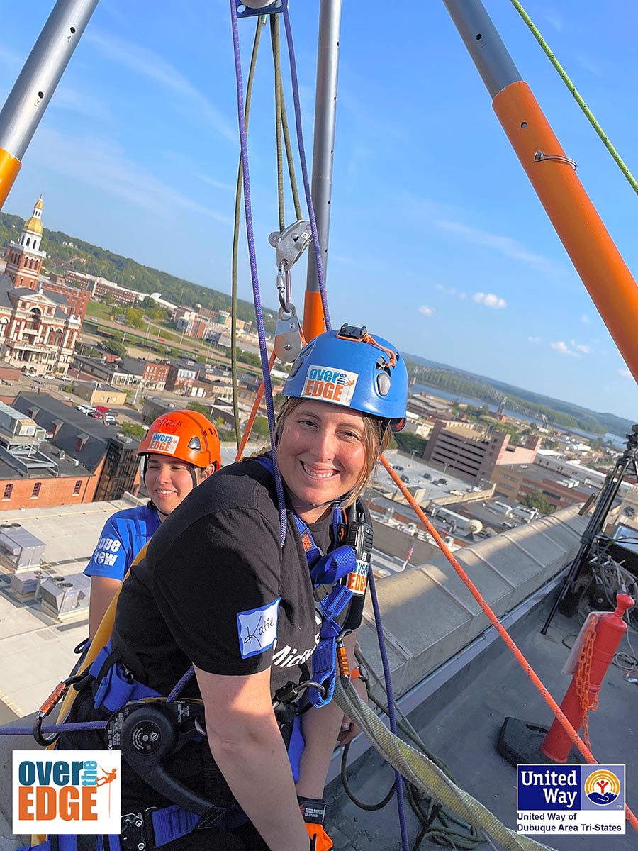 MidWestOne employee Katie Symmonds going over the edge of the MidWestOne Bank building in Dubuque