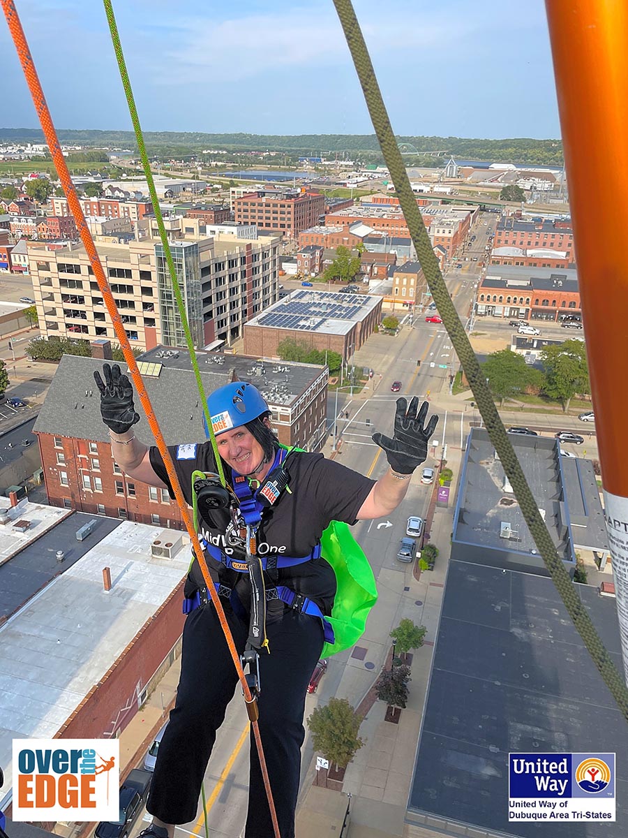 MidWestOne employee Lynne Hager going over the edge of the MidWestOne Bank building in Dubuque