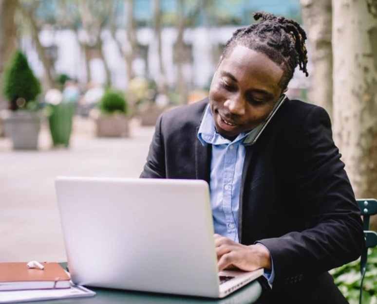 Man on laptop accessing Wire Transfer Services.